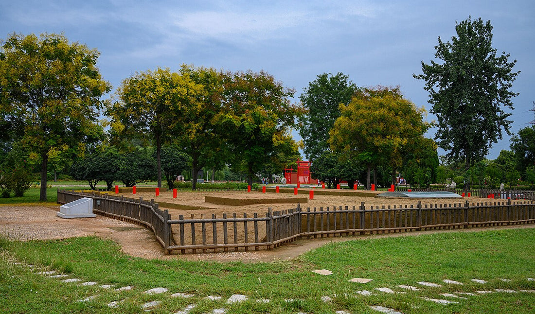 Low earthen foundation display behind a fence at Yinxu in Anyang