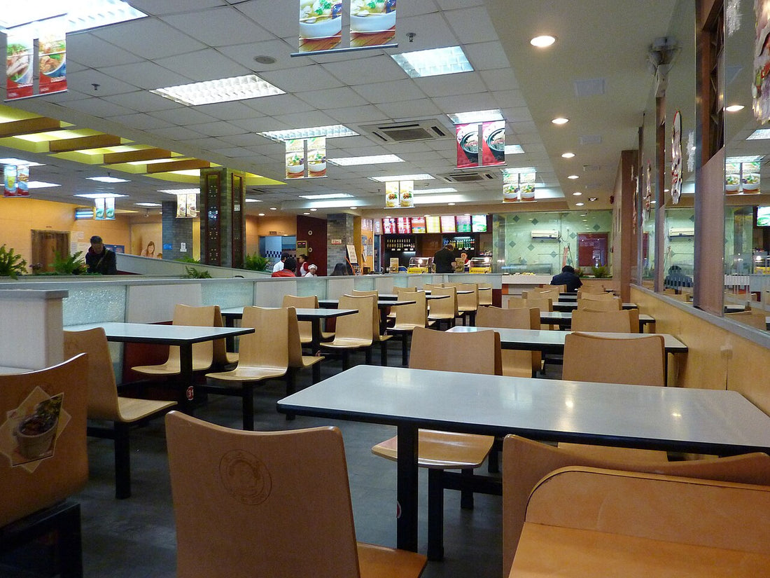 Tables, chairs and a service counter inside a casual Shanghai dumpling restaurant