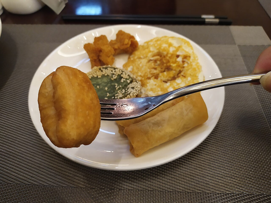 Plate of egg and cooked breakfast foods at a hotel in Shantou