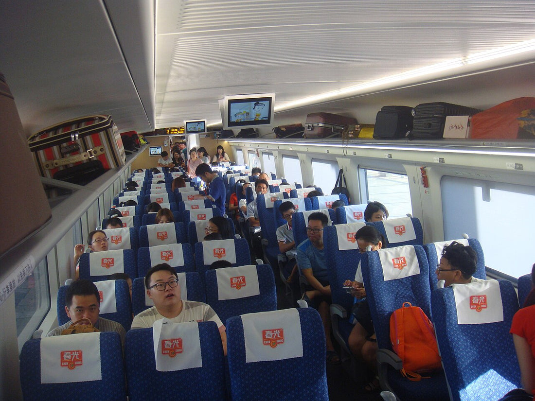 Rows of seats and overhead luggage racks on a Hainan high-speed train