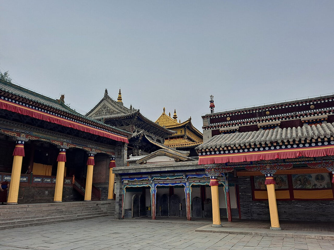 Kumbum Monastery courtyard with steps, yellow columns and golden roof