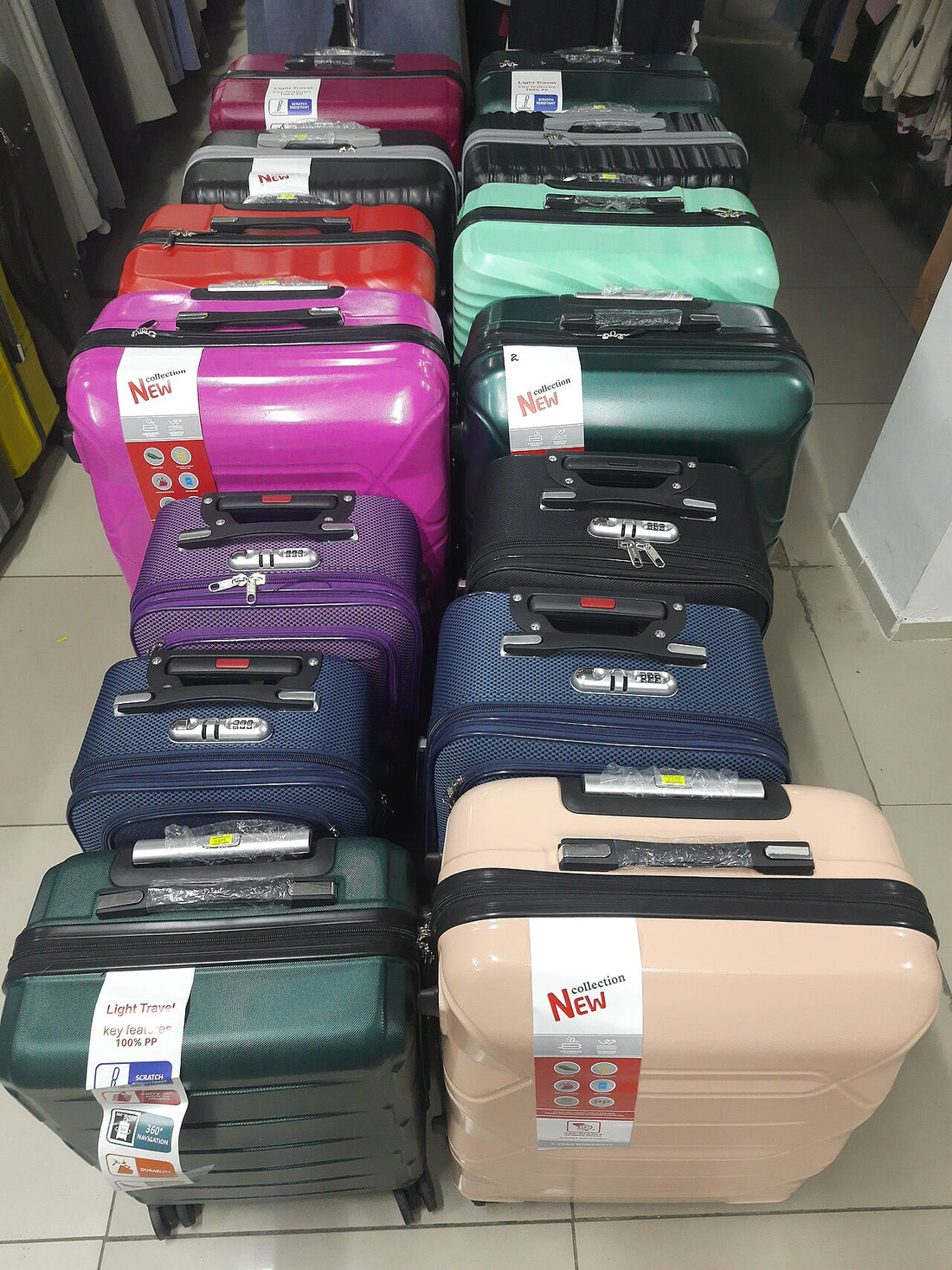 Different sizes of hard-shell wheeled suitcases displayed side by side