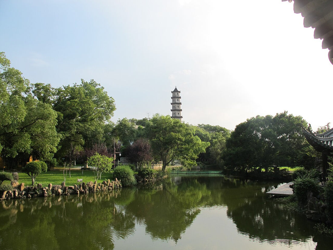 West Pagoda rising above trees and a pond on Jiangxin Island in Wenzhou