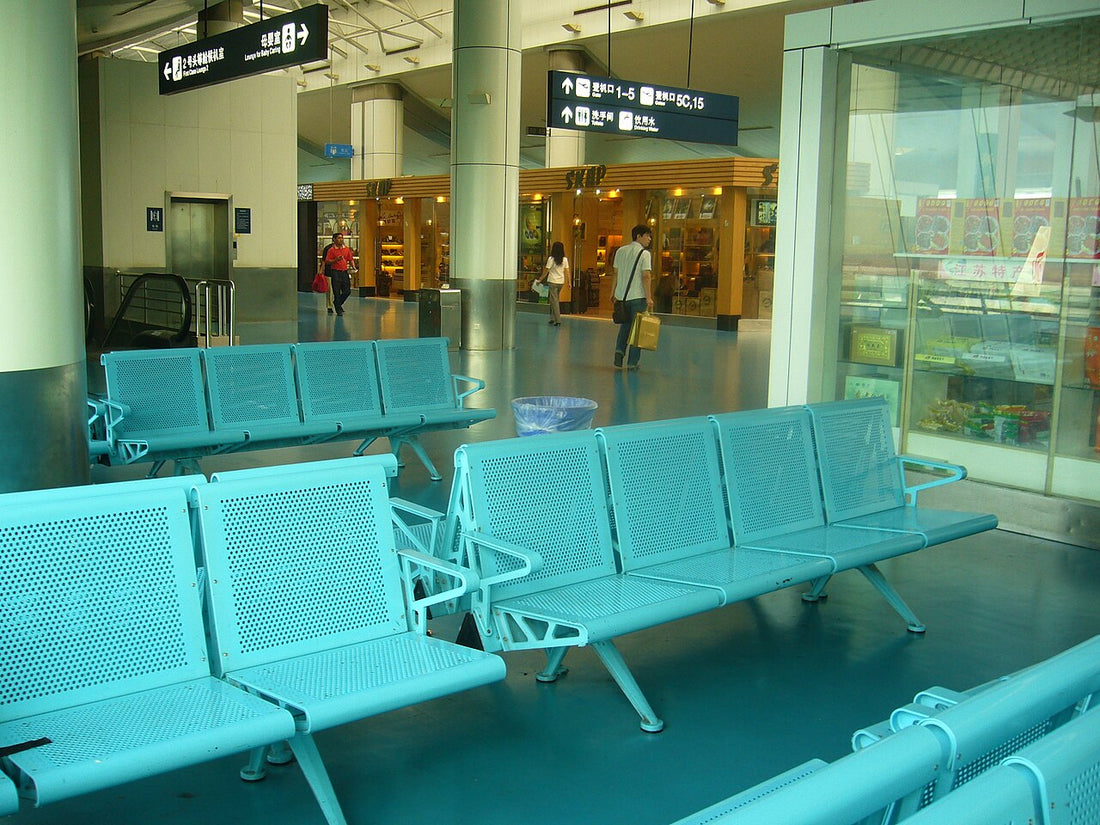 Rows of seats and overhead wayfinding signs inside Nanjing Lukou Airport