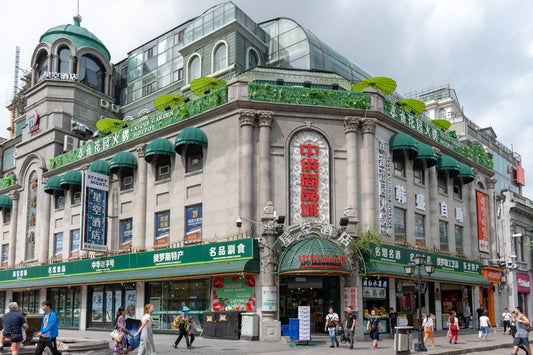 Corner commercial building with green awnings on Harbin's Central Street