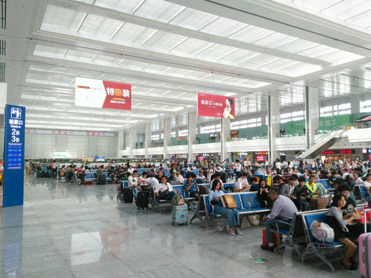 Large railway departure hall in Chongqing with seats and passenger information boards