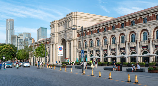 Arched Minyuan Stadium facade beside a street in Tianjin's Five Avenues neighbourhood