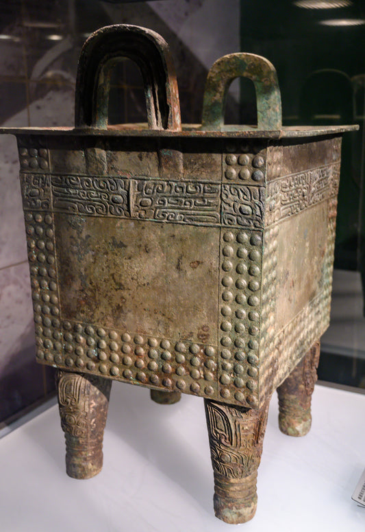 Rectangular bronze vessel with four legs and upright handles at Henan Museum