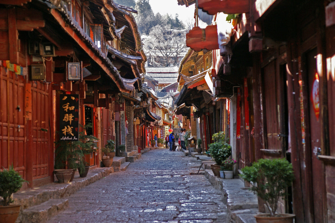 Stone-paved lane between timber-fronted buildings in Lijiang Old Town