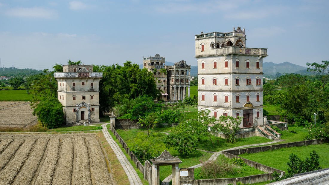 Fortified diaolou towers beside fields in Zili Village, Kaiping
